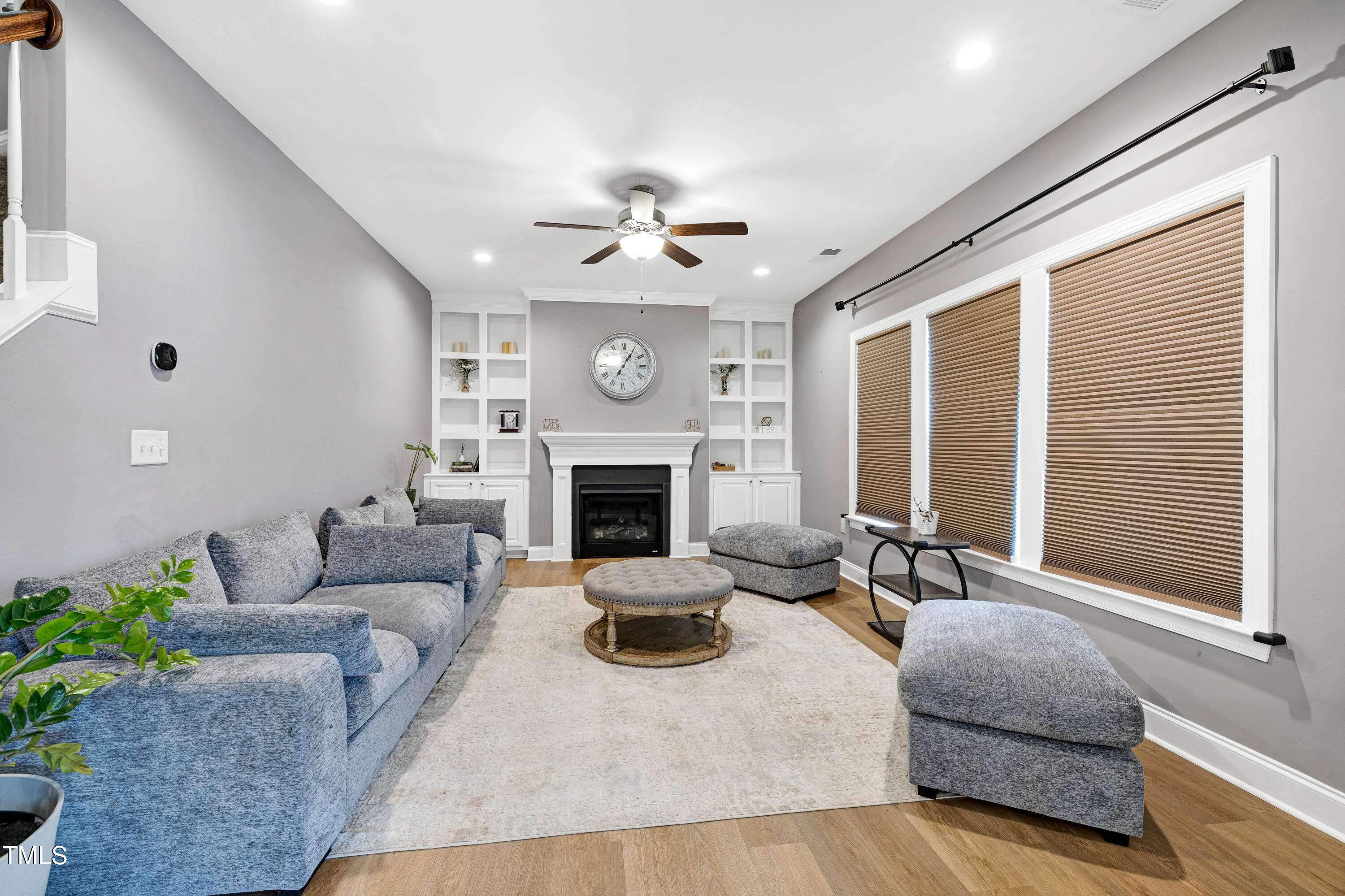 1417 Slate Ridge Road Knightdale, NC 27545 - Photo 17 of 66 a living room with furniture a fireplace and a large window