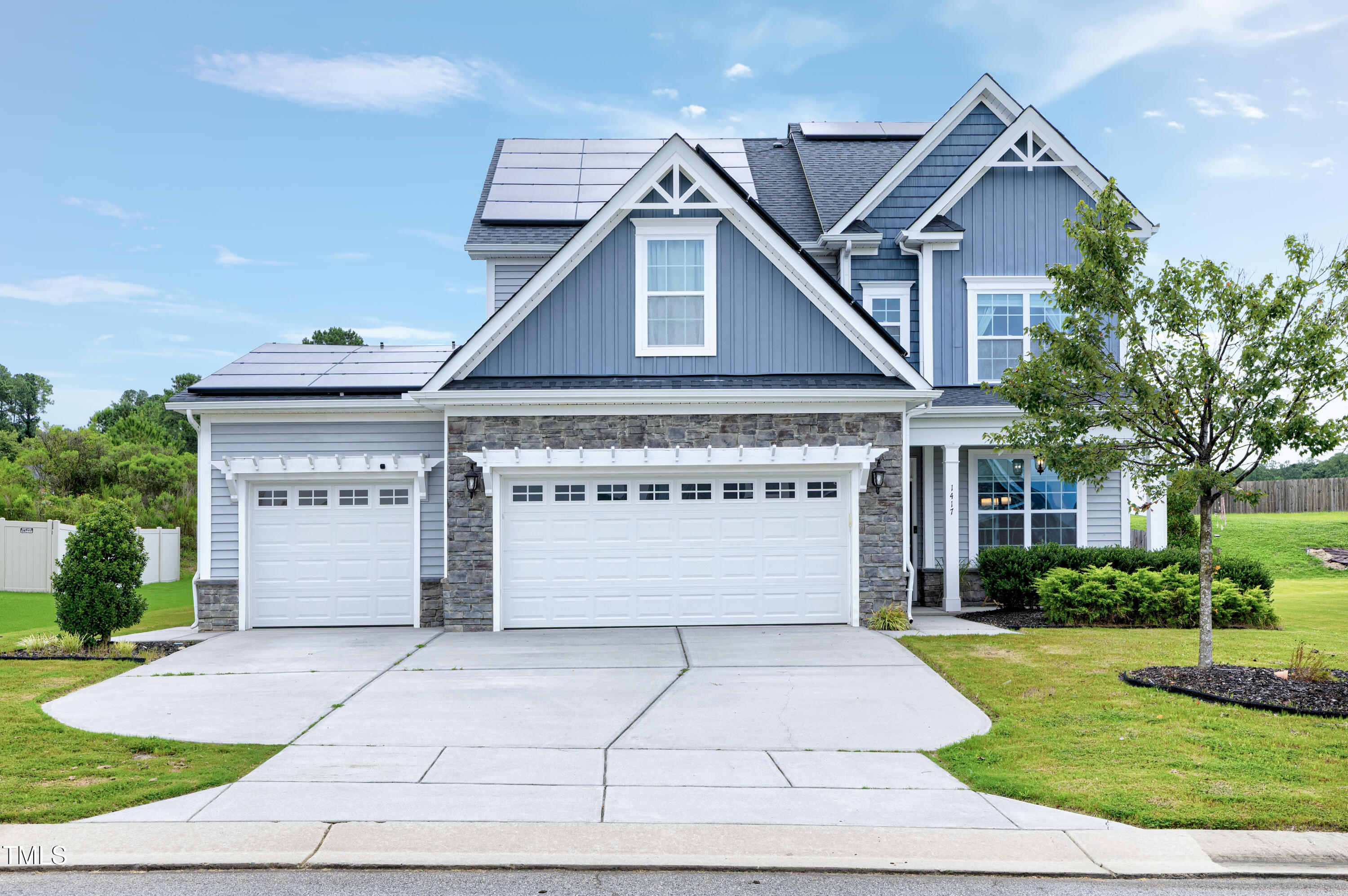 1417 Slate Ridge Road Knightdale, NC 27545 - Photo 2 of 66 a front view of a house with a garden and garage