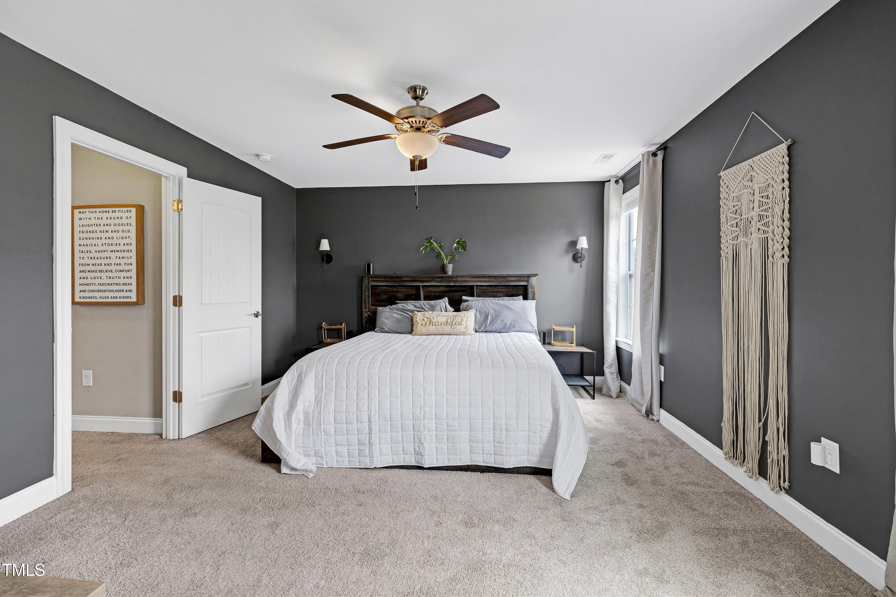 1417 Slate Ridge Road Knightdale, NC 27545 - Photo 24 of 66 a bedroom with a bed and window