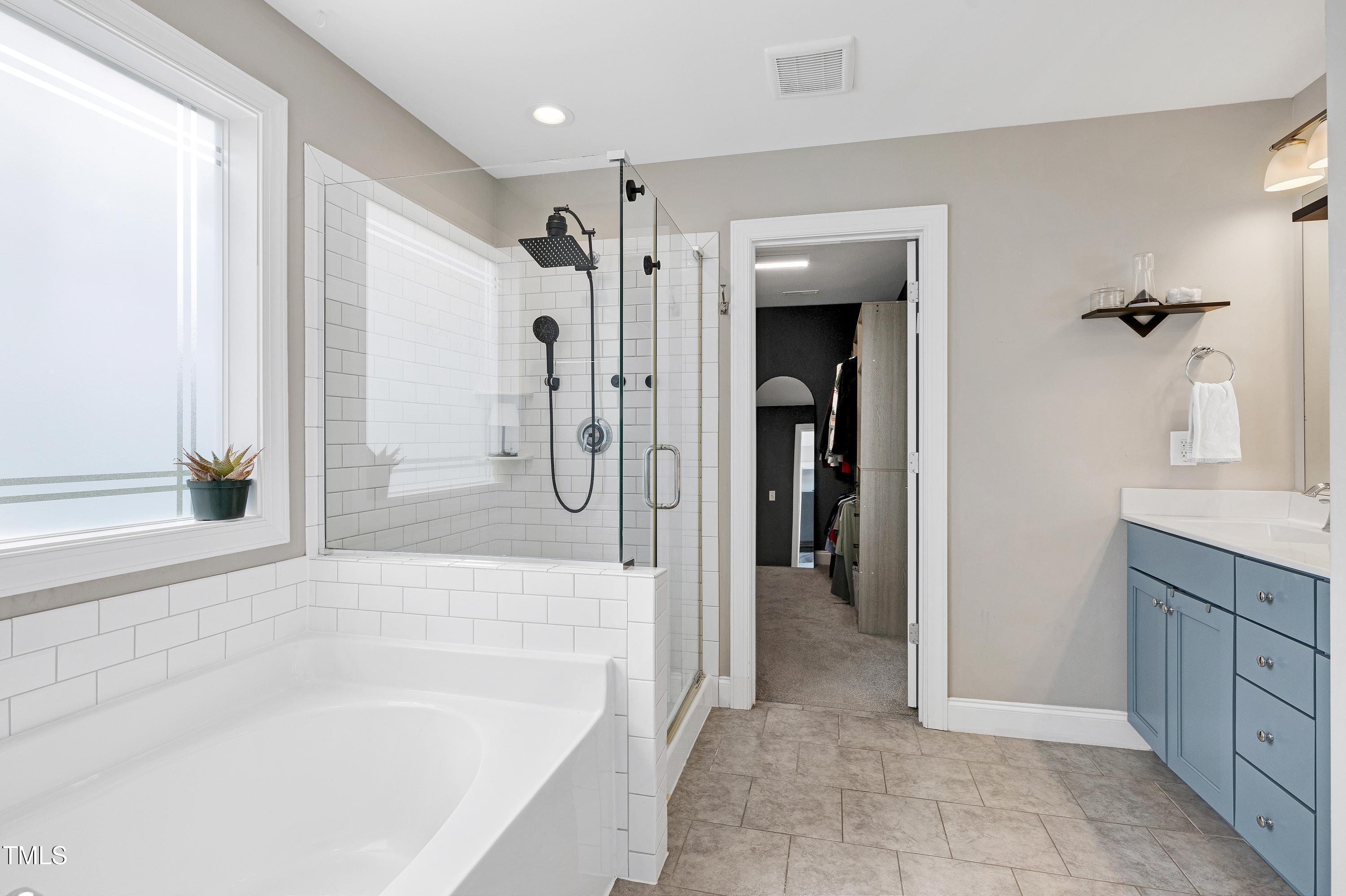 1417 Slate Ridge Road Knightdale, NC 27545 - Photo 25 of 66 a spacious bathroom with a bathtub and a shower