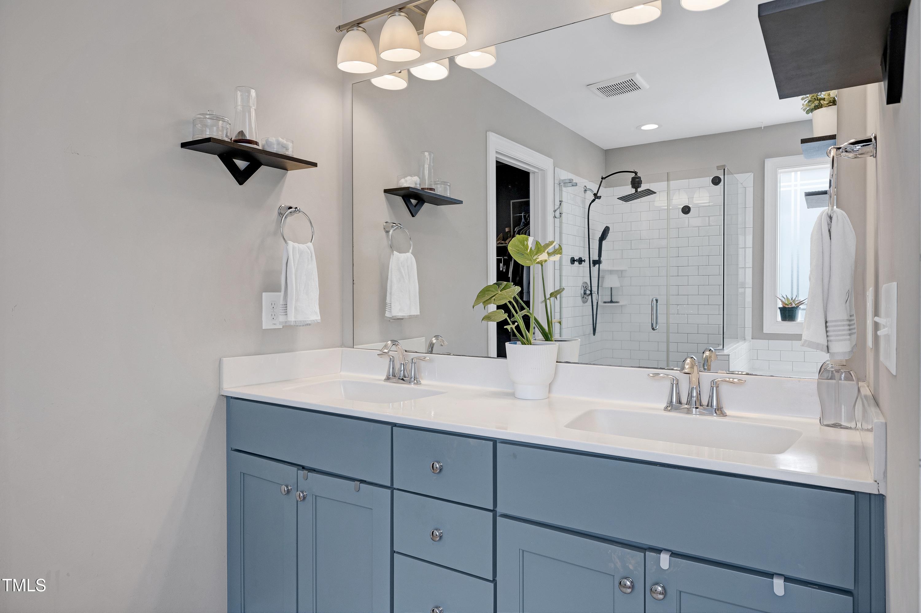 1417 Slate Ridge Road Knightdale, NC 27545 - Photo 27 of 66 a bathroom with a sink double vanity and a mirror