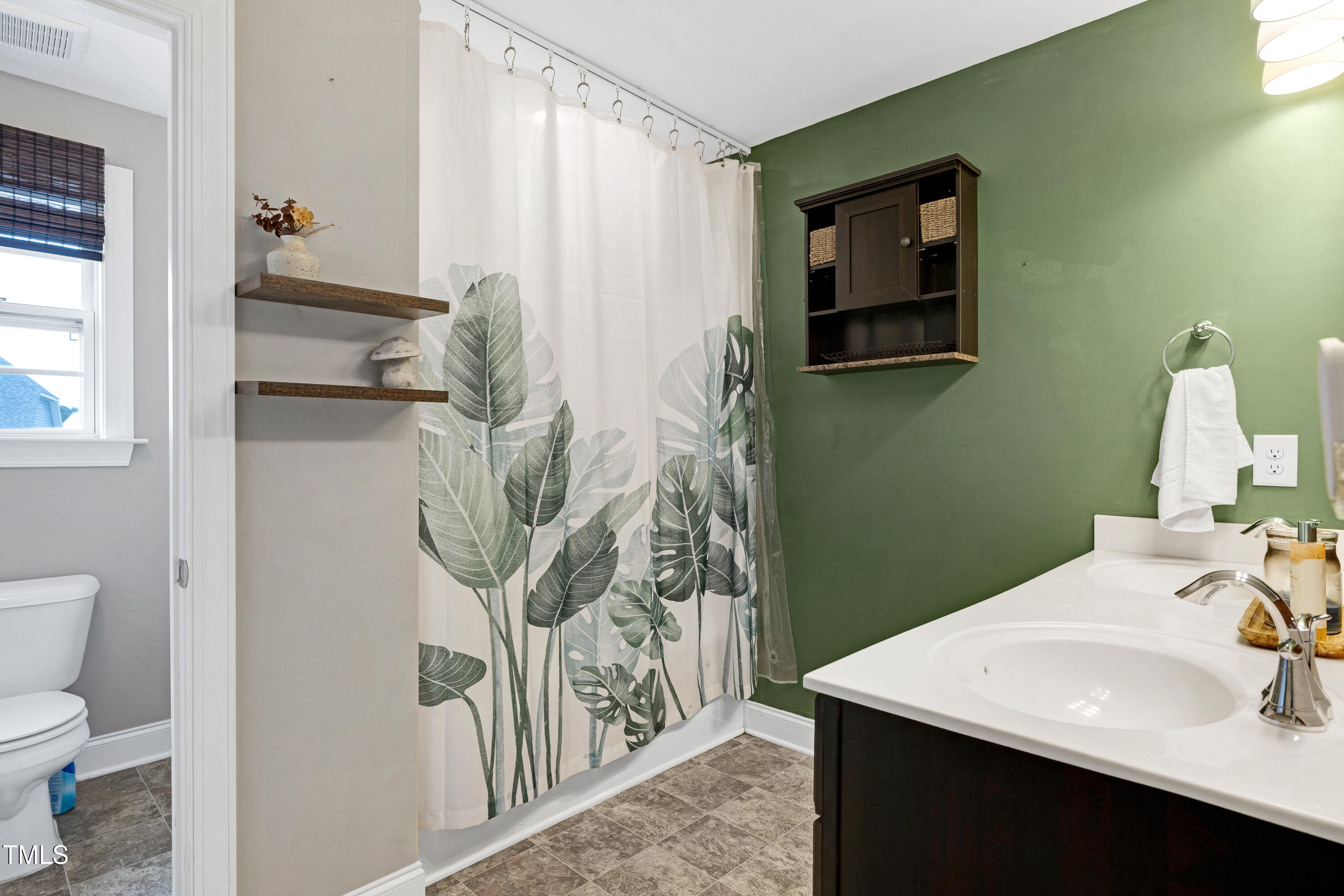 1417 Slate Ridge Road Knightdale, NC 27545 - Photo 29 of 66 a bathroom with a sink and mirror with toilet
