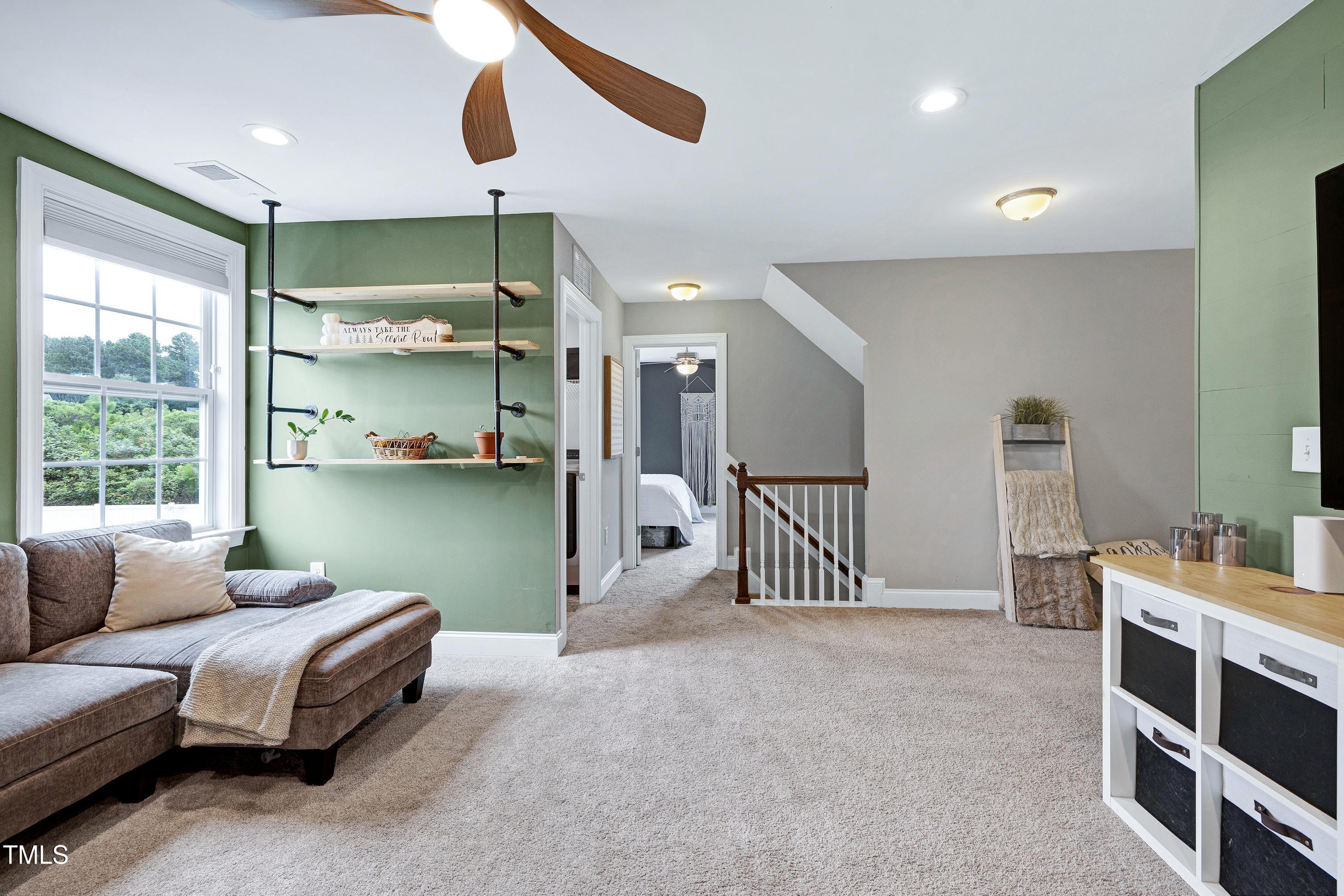 1417 Slate Ridge Road Knightdale, NC 27545 - Photo 33 of 66 a living room with furniture and a chandelier