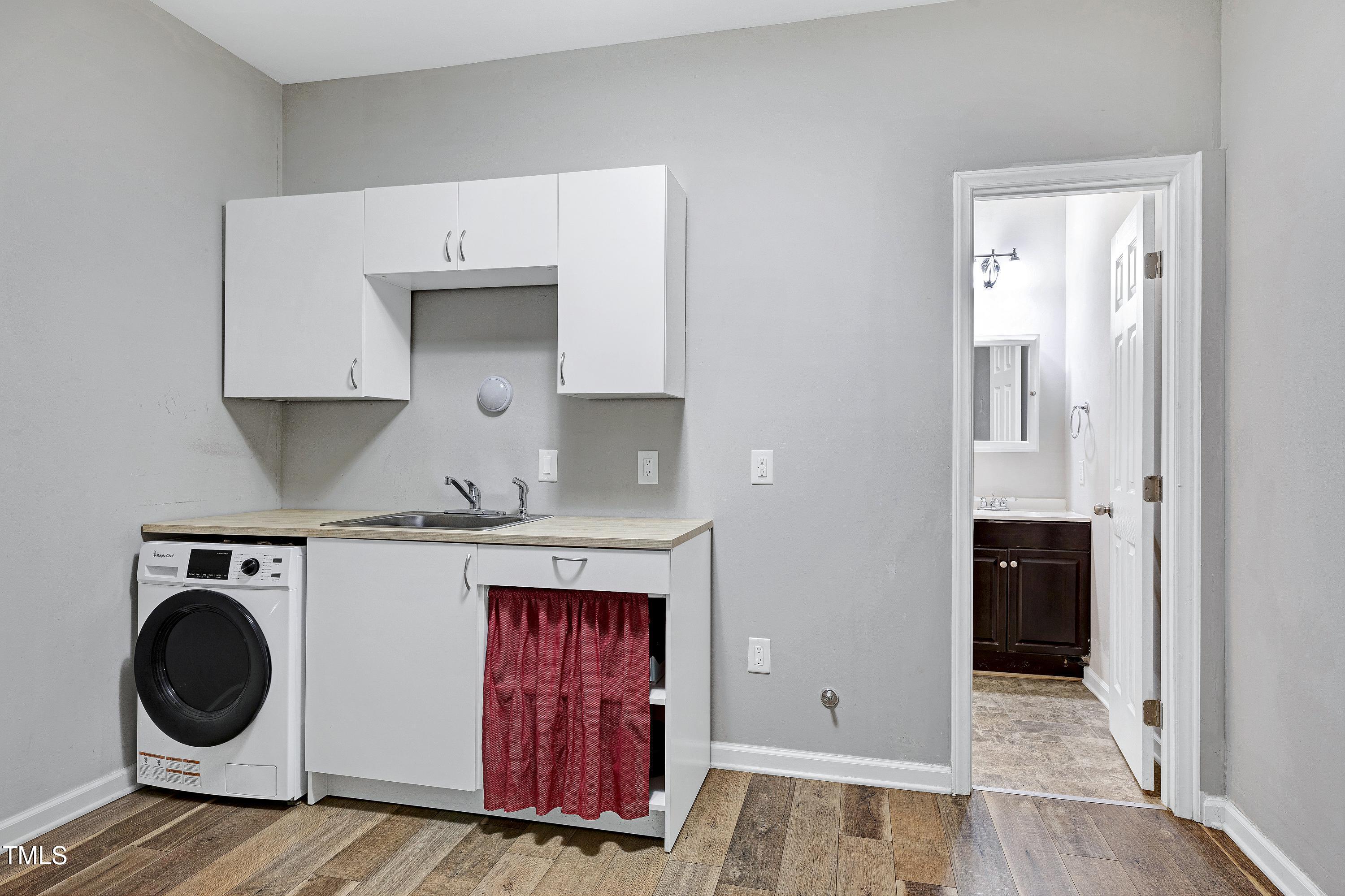 1417 Slate Ridge Road Knightdale, NC 27545 - Photo 46 of 66 a view of a kitchen with sink and cabinets