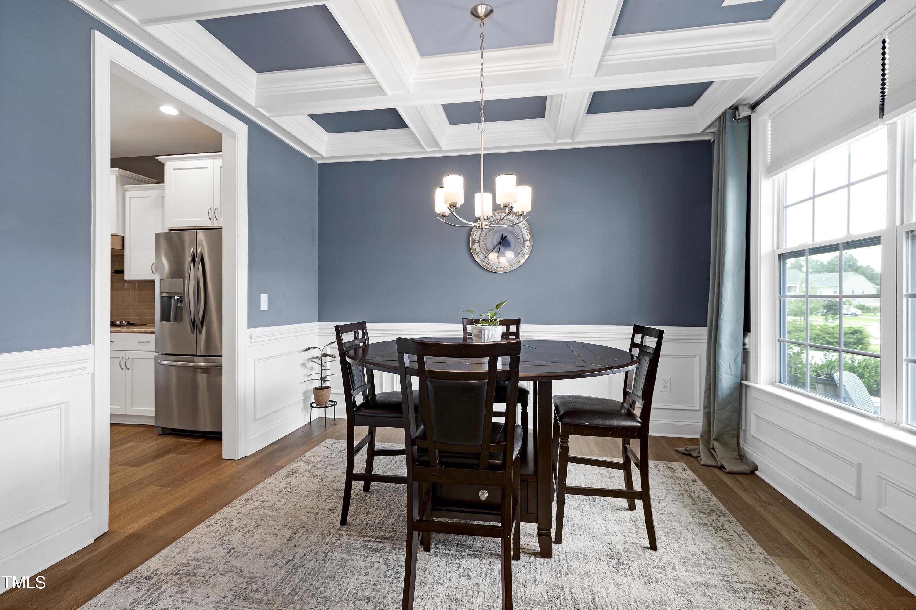 1417 Slate Ridge Road Knightdale, NC 27545 - Photo 7 of 66 a view of a dining room with furniture a chandelier and wooden floor