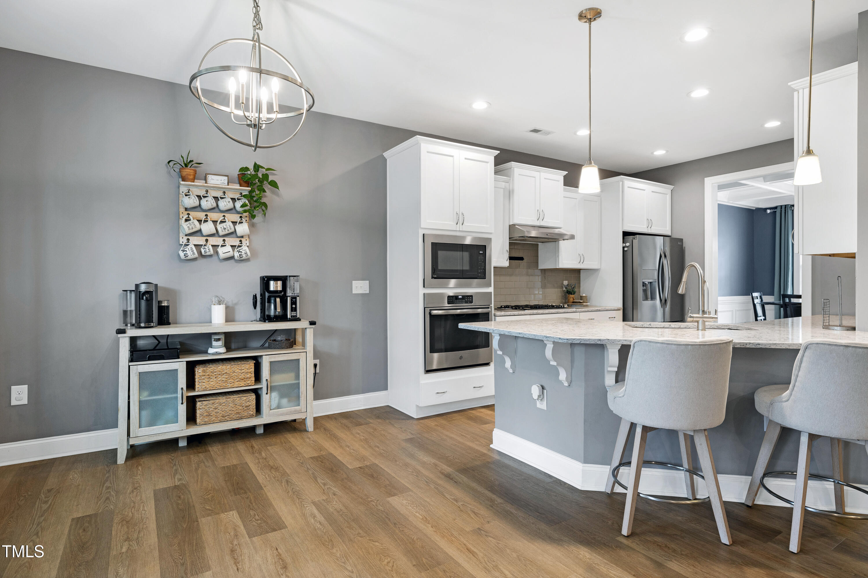 1417 Slate Ridge Road Knightdale, NC 27545 - Photo 10 of 66 a kitchen with stainless steel appliances kitchen island a large island in the center and cabinets
