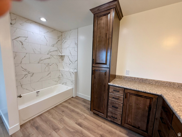 2865 North 3250 W Road Sutherland, UT 84624 - Photo 11 of 28 Bathroom featuring a white tub with marble-look tile surround and recessed lighting