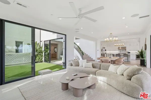 a kitchen with stainless steel appliances kitchen island granite countertop a table and chairs in it
