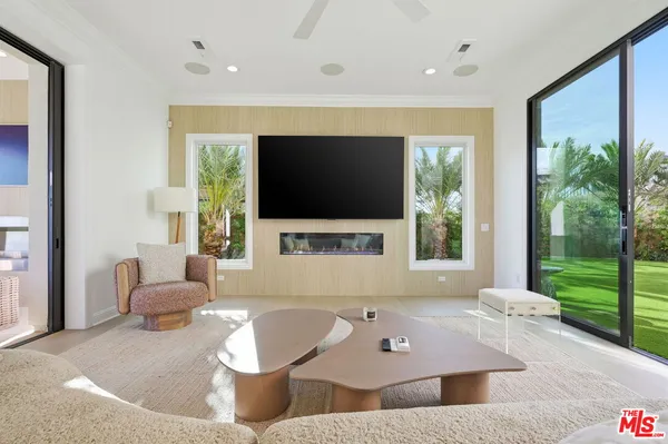 a kitchen with stainless steel appliances a table and chairs in it