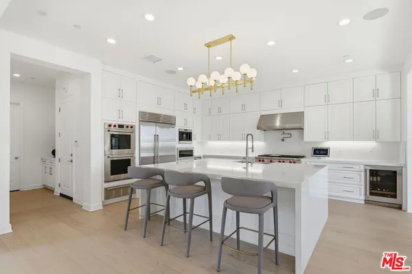 a stove top oven sitting inside of a kitchen