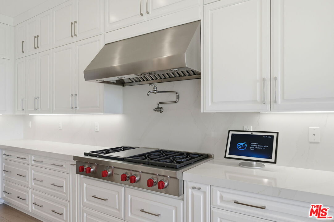 20448 Liverpool Way Porter Ranch, CA 91326 - Photo 17 of 61 a stove top oven sitting inside of a kitchen