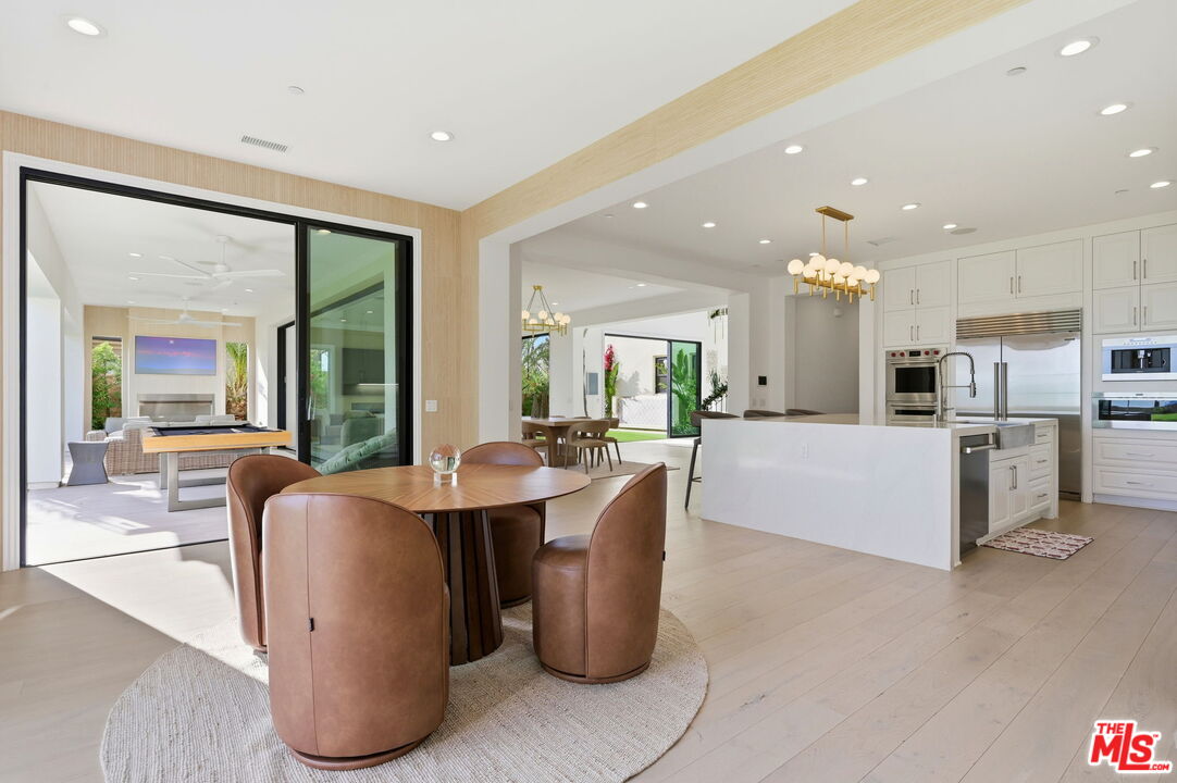 20448 Liverpool Way Porter Ranch, CA 91326 - Photo 19 of 61 a living room with furniture a large window with kitchen view