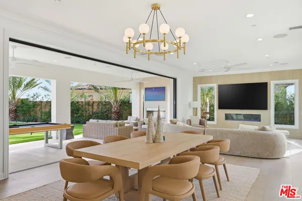 a living room with furniture and a ceiling fan
