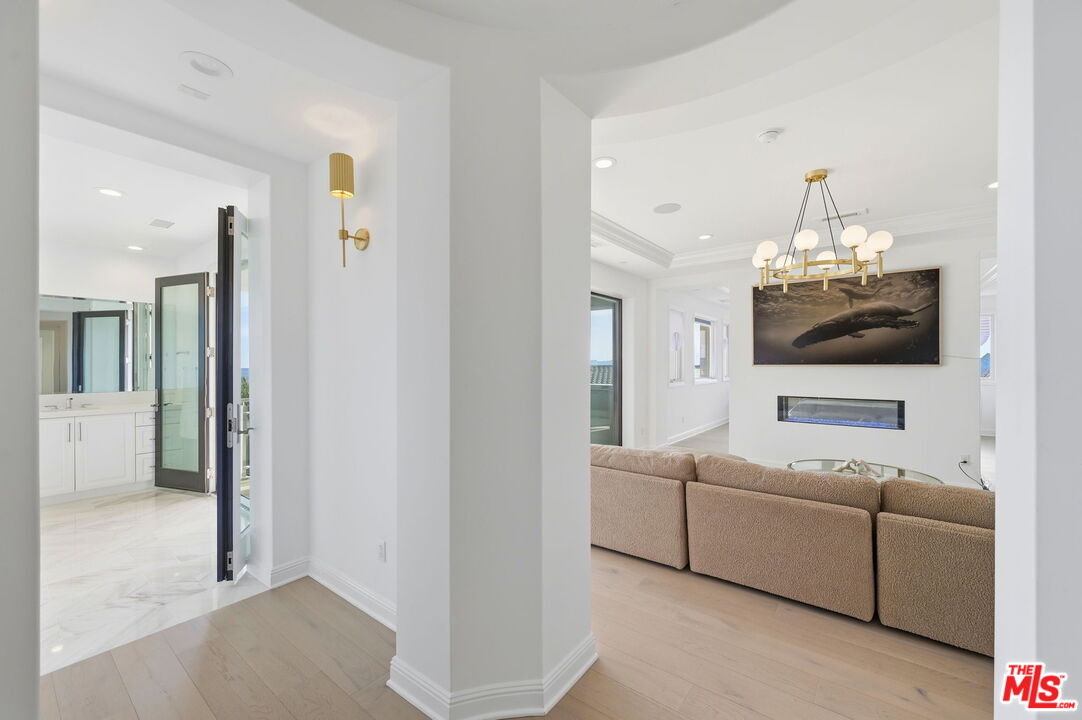 20448 Liverpool Way Porter Ranch, CA 91326 - Photo 27 of 61 a living room with furniture and a chandelier