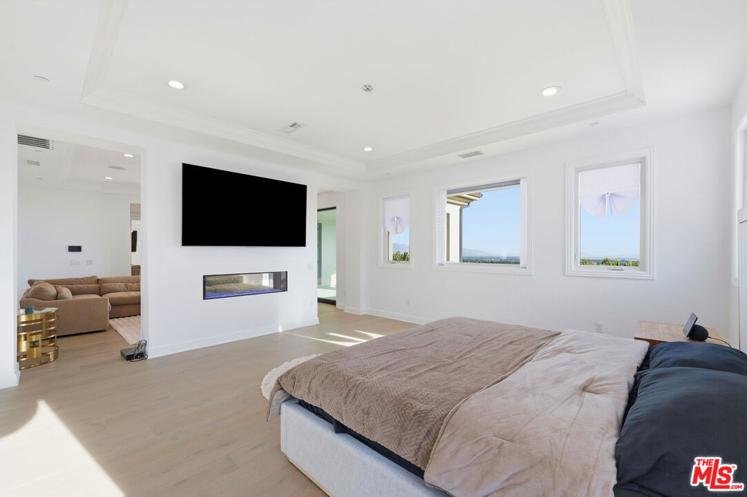 20448 Liverpool Way Porter Ranch, CA 91326 - Photo 30 of 61 a bedroom with a bed and a flat screen tv