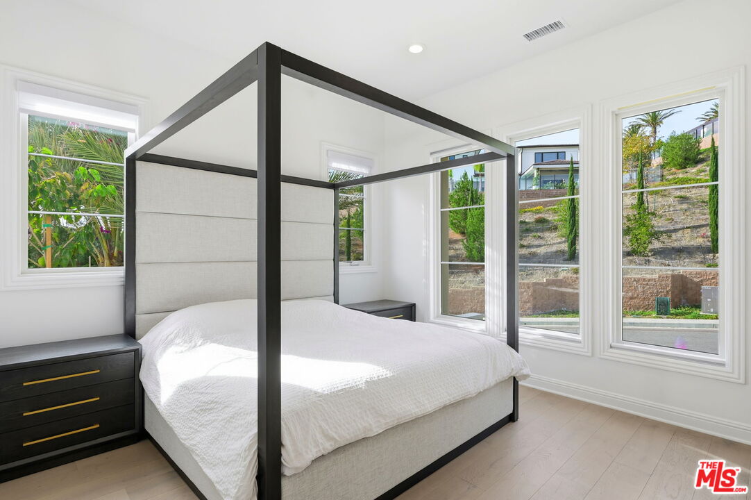 20448 Liverpool Way Porter Ranch, CA 91326 - Photo 32 of 61 a bed sitting in a bedroom next to a window