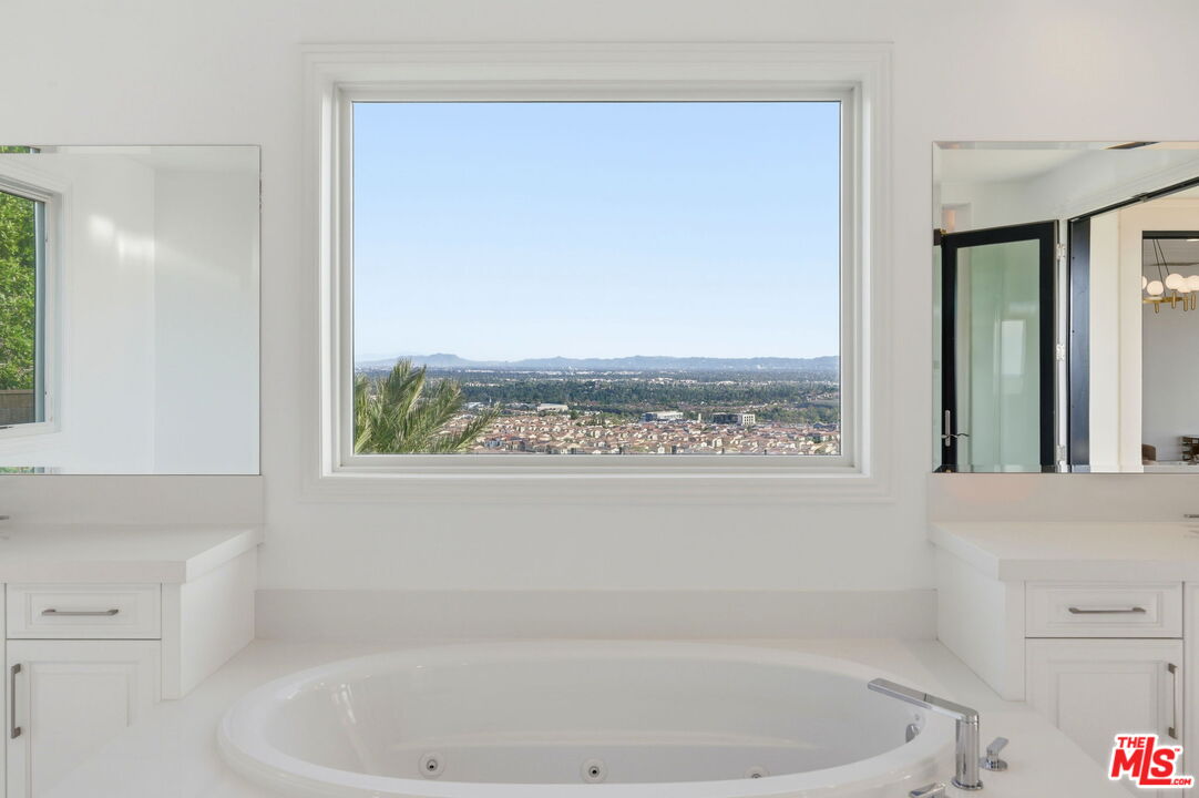 20448 Liverpool Way Porter Ranch, CA 91326 - Photo 35 of 61 a bath tub sitting next to a window