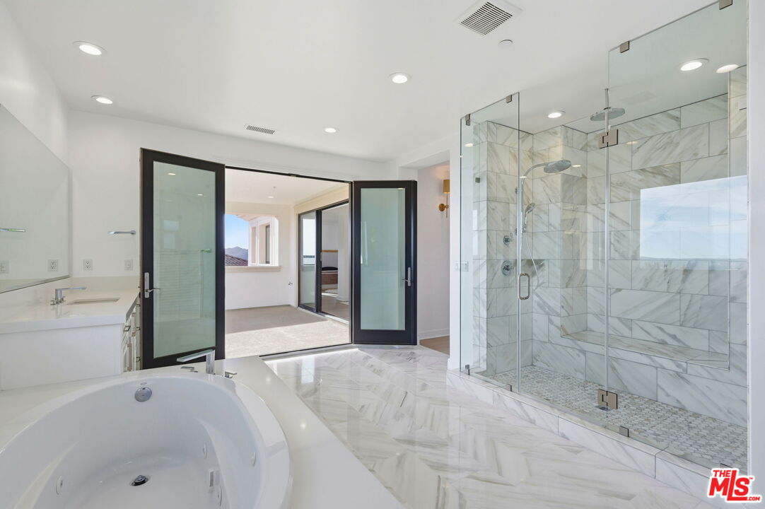 20448 Liverpool Way Porter Ranch, CA 91326 - Photo 36 of 61 a bathroom with a shower and a tub