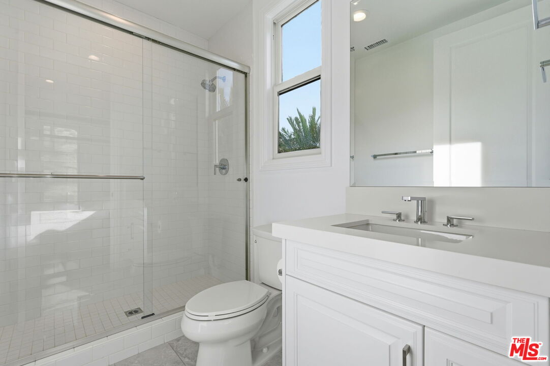 20448 Liverpool Way Porter Ranch, CA 91326 - Photo 39 of 61 a bathroom with a granite countertop sink toilet and shower