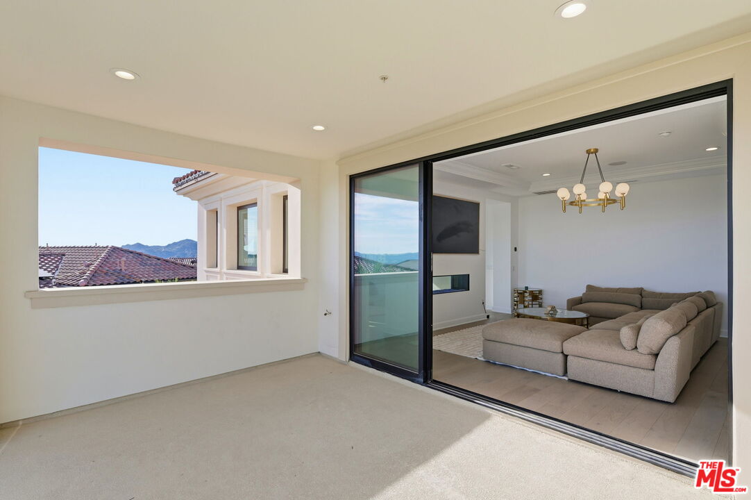 20448 Liverpool Way Porter Ranch, CA 91326 - Photo 43 of 61 a living room with furniture and a chandelier