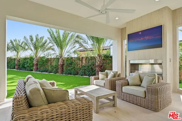 a view of a house with swimming pool and porch with furniture