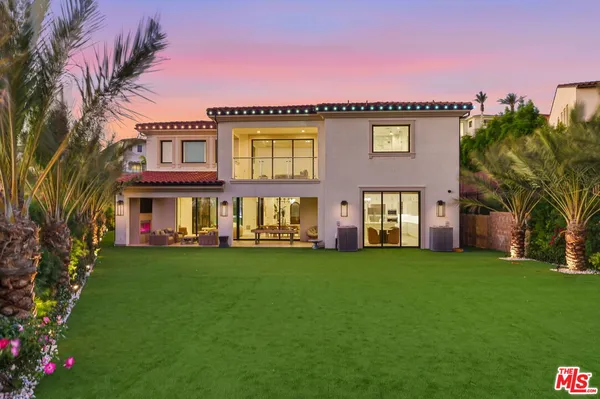 a view of a swimming pool with a garden and plants