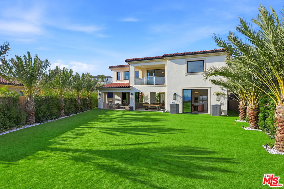 20448 Liverpool Way Porter Ranch, CA 91326 - Photo 54 of 61 a front view of a house with a garden