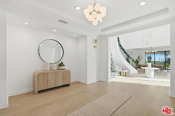 a living room with fireplace furniture and a chandelier