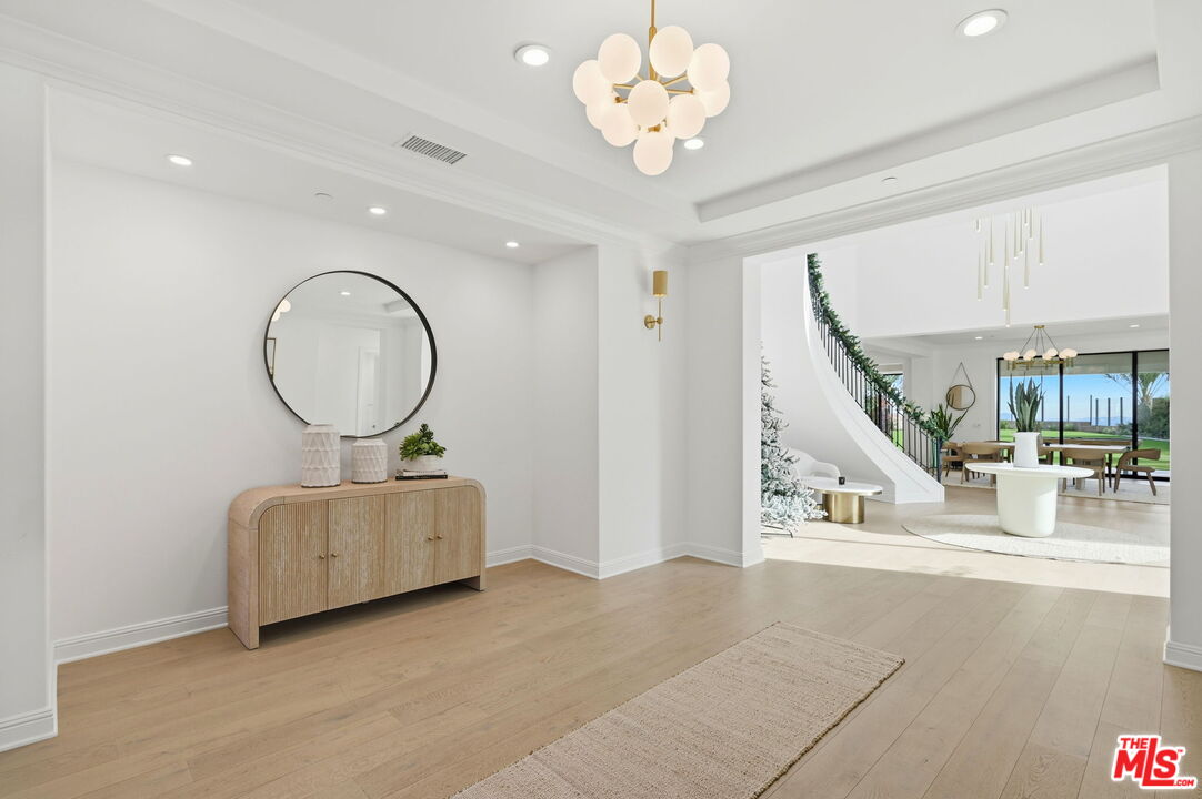 20448 Liverpool Way Porter Ranch, CA 91326 - Photo 6 of 61 a living room with fireplace furniture and a chandelier