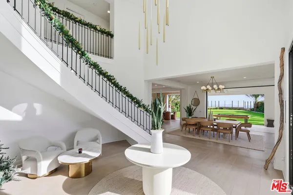 a dining room with furniture a rug and white walls