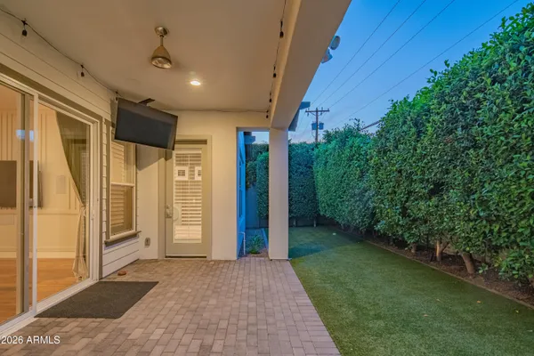 a view of a porch in front of a house with a backyard