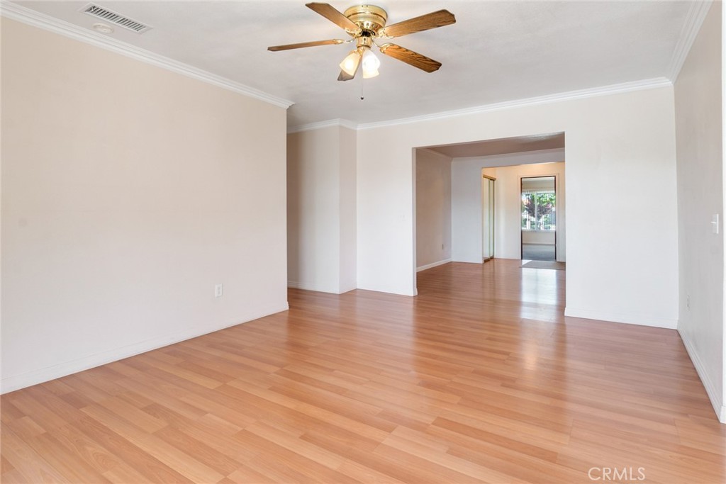 9130 Duncan Avenue Riverside, CA 92503 - Photo 9 of 34 a view of an empty room with window and wooden floor