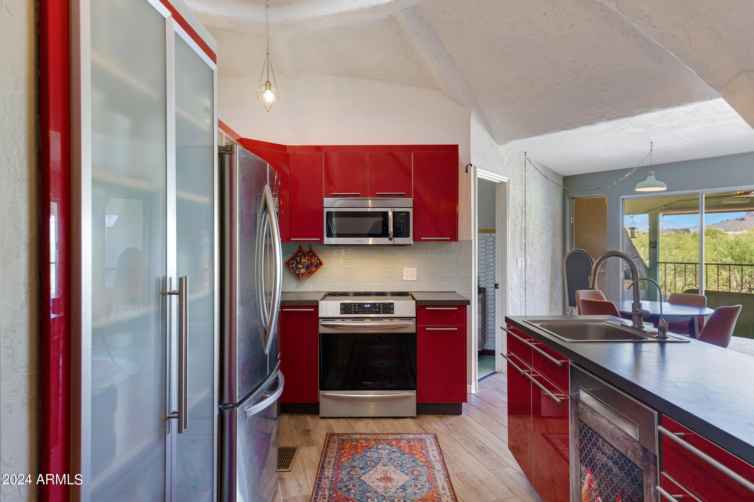 625 South Arroya Road Apache Junction, AZ 85119 - Photo 8 of 48 a kitchen with stainless steel appliances granite countertop a stove a sink and a refrigerator