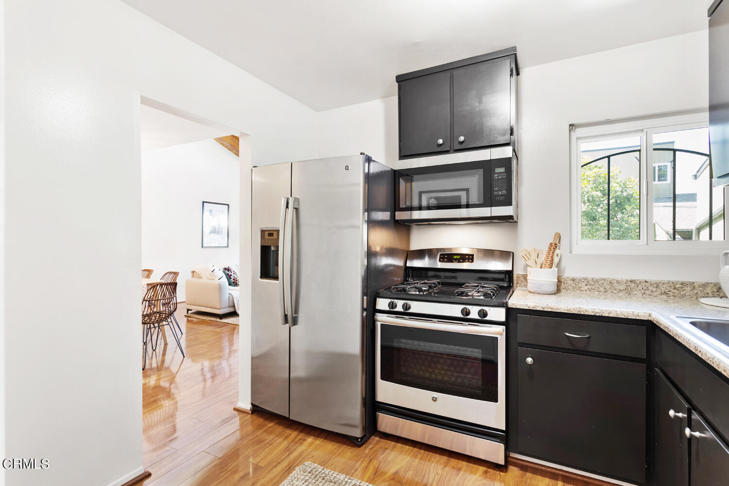 4828 Hollow Corner Road, Unit 293 Culver City, CA 90230 - Photo 8 of 24 a kitchen with granite countertop a stove microwave and refrigerator