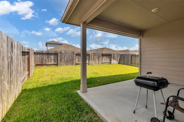 a view of a house with a swimming pool and a yard