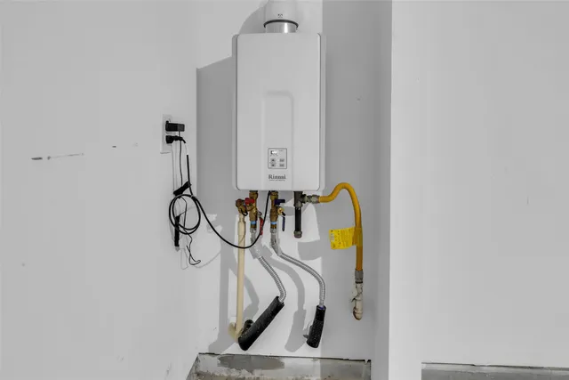 a kitchen with stainless steel appliances kitchen island granite countertop a refrigerator and a sink