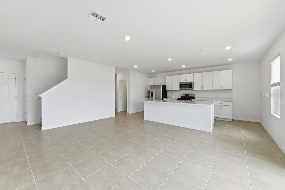 13235 Commons Avenue Parrish, FL 34219 - Photo 12 of 37 a view of kitchen with kitchen island a sink a center island stainless steel appliances and a cabinets