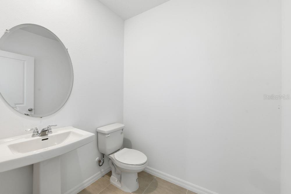13235 Commons Avenue Parrish, FL 34219 - Photo 25 of 37 a bathroom with a toilet a sink and mirror