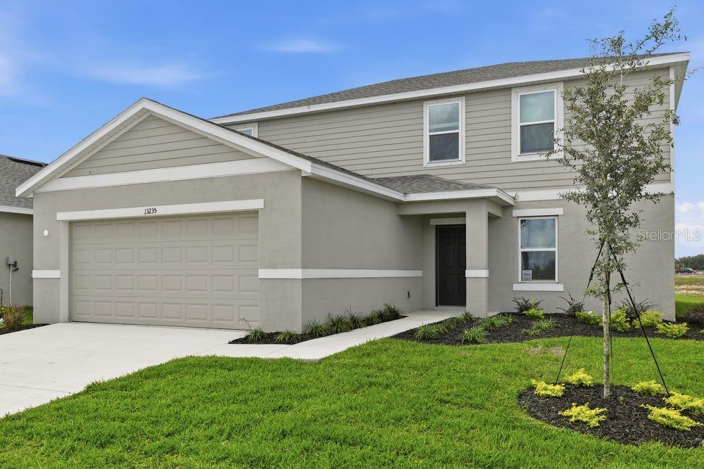 13235 Commons Avenue Parrish, FL 34219 - Photo 30 of 37 a view of a house with a yard and garage