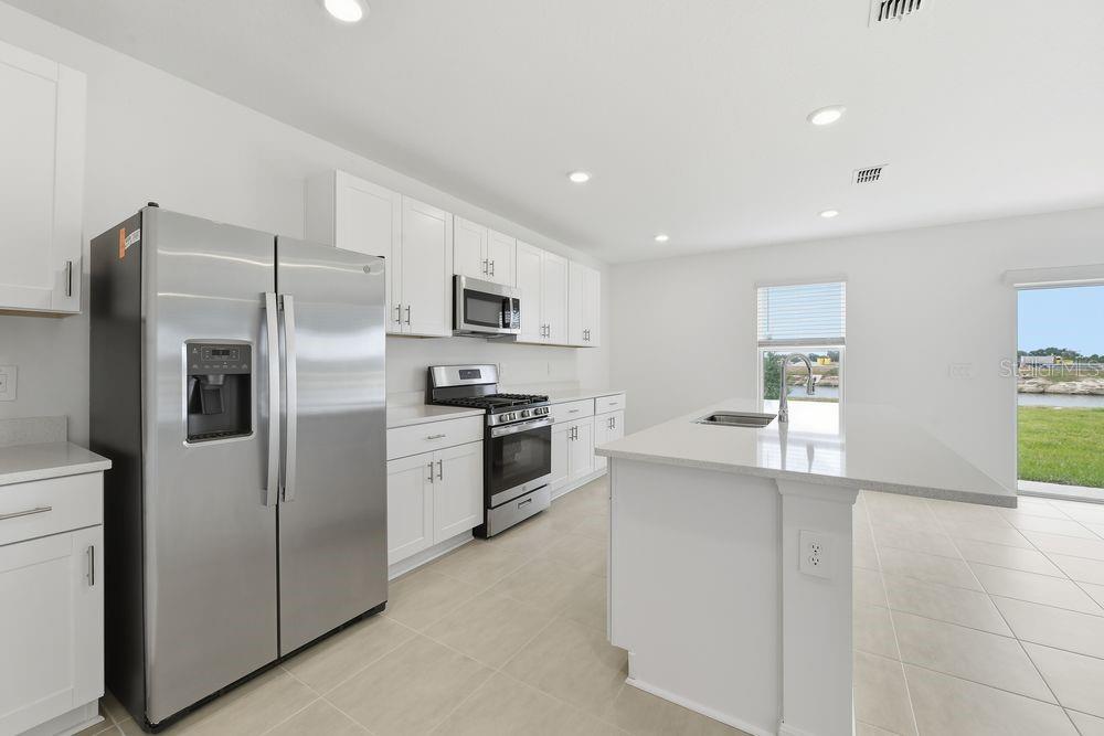 13235 Commons Avenue Parrish, FL 34219 - Photo 3 of 37 a kitchen with cabinets and stainless steel appliances