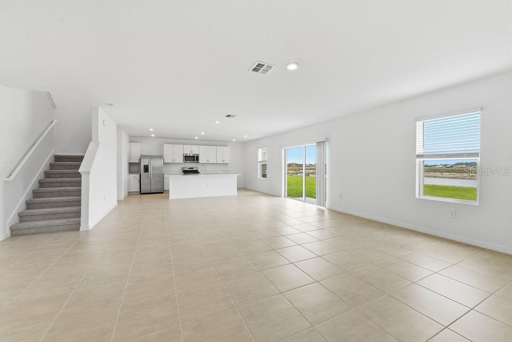 13235 Commons Avenue Parrish, FL 34219 - Photo 10 of 37 a view of empty room with stairs and wooden floor
