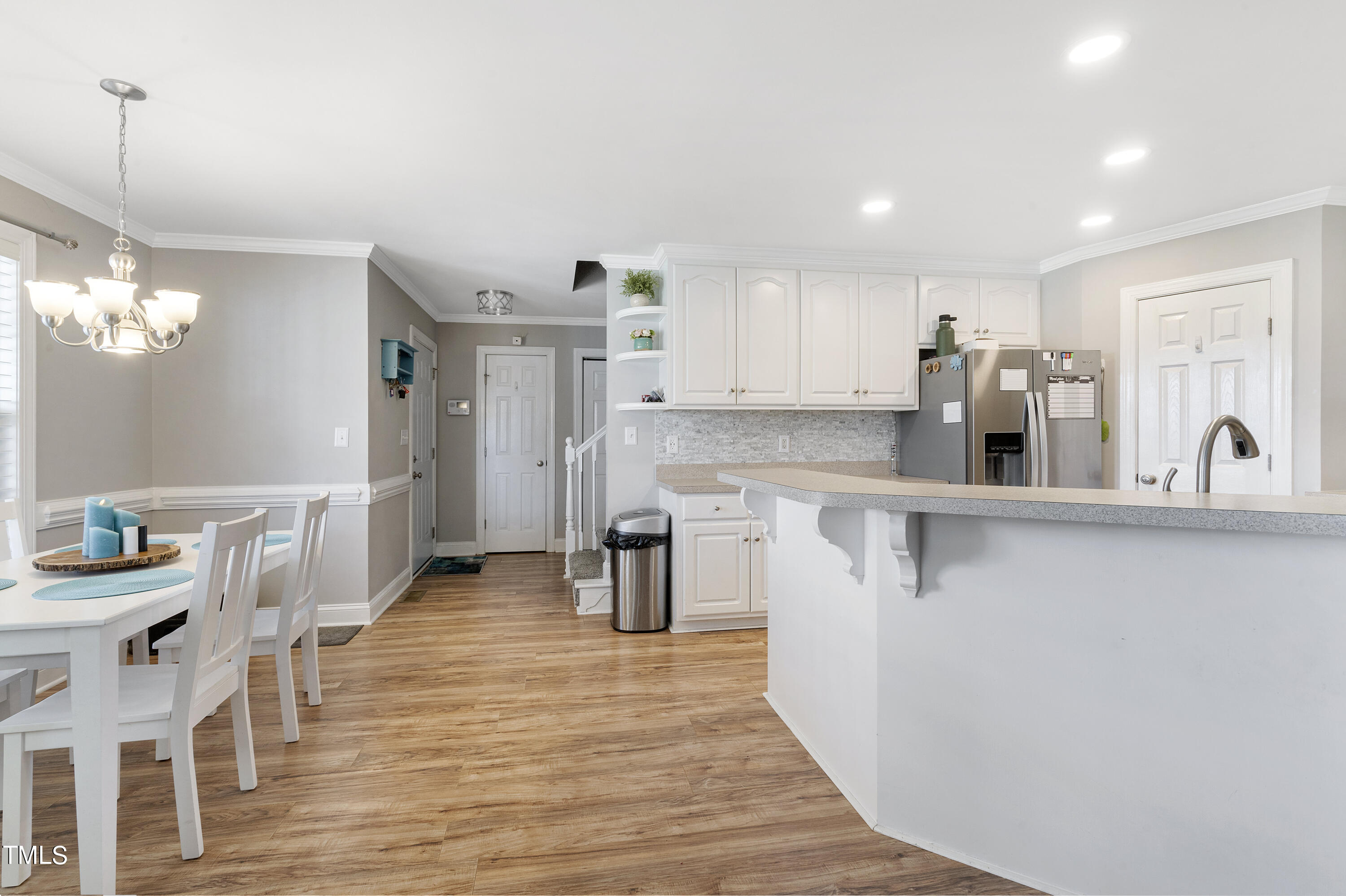 6910 Rock Ridge Sims Road Sims, NC 27880 - Photo 11 of 45 a kitchen with stainless steel appliances a refrigerator and a wooden floor