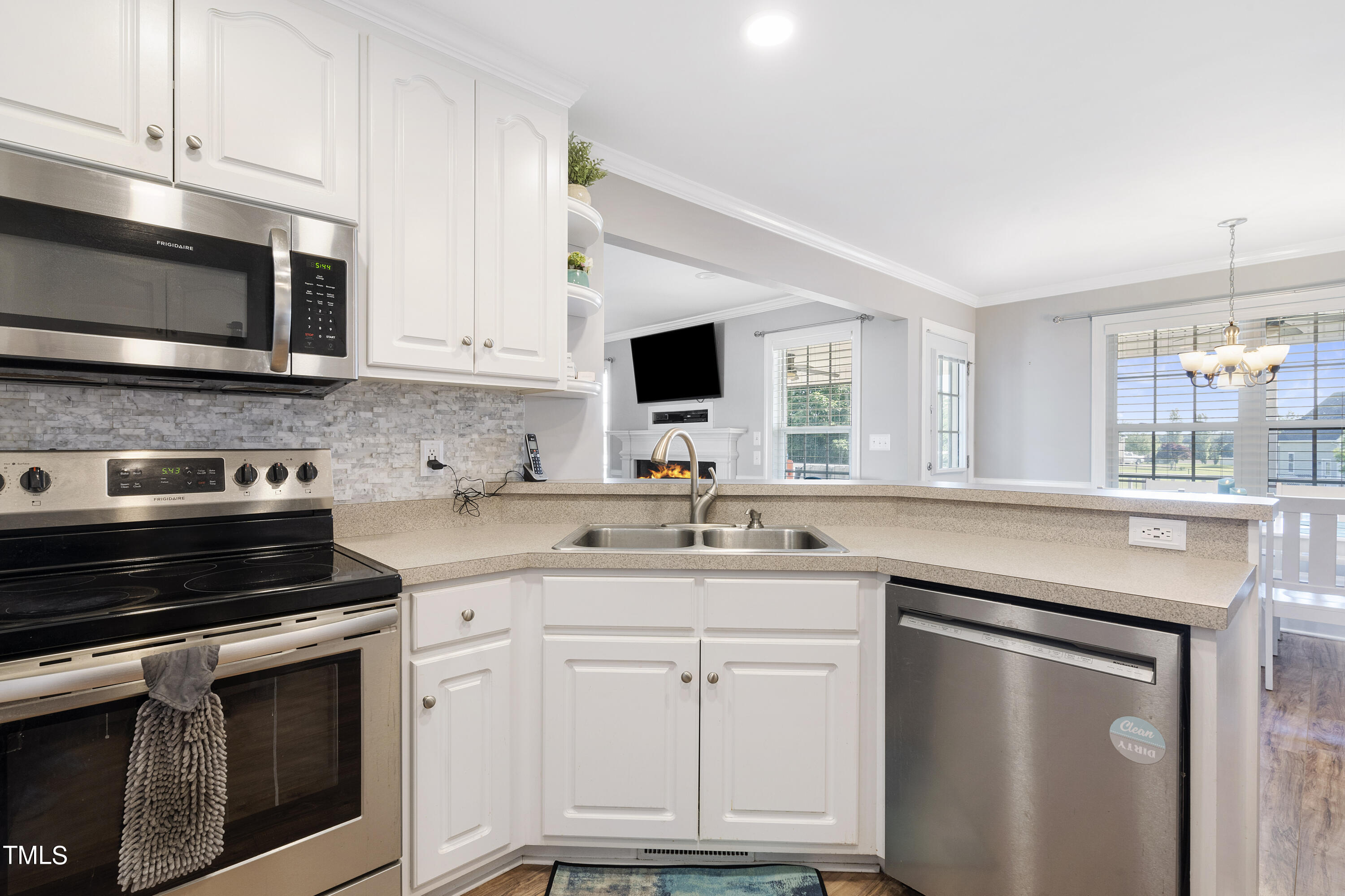 6910 Rock Ridge Sims Road Sims, NC 27880 - Photo 13 of 45 a kitchen with white cabinets and appliances