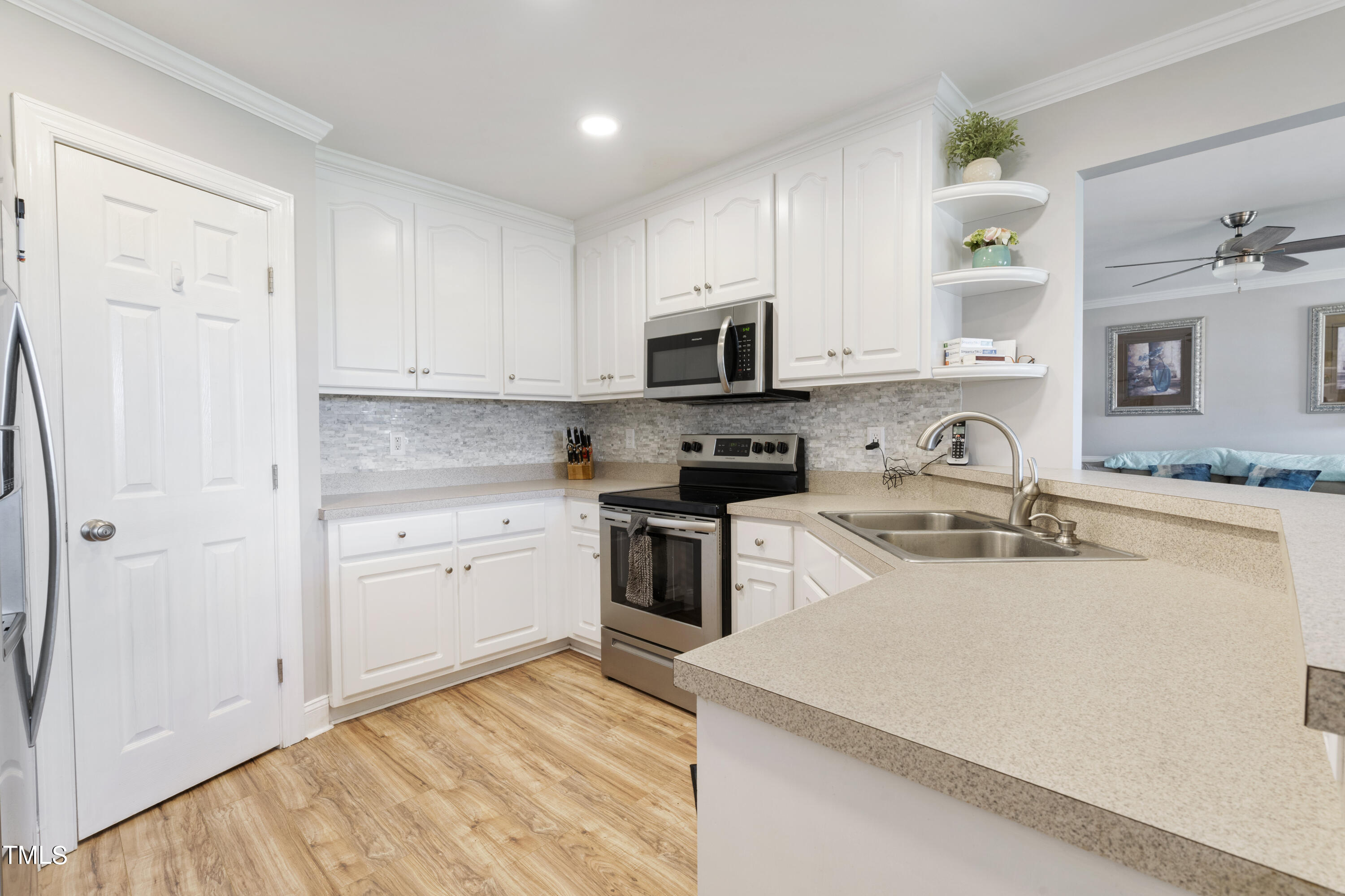 6910 Rock Ridge Sims Road Sims, NC 27880 - Photo 14 of 45 a kitchen with granite countertop a sink stove and refrigerator