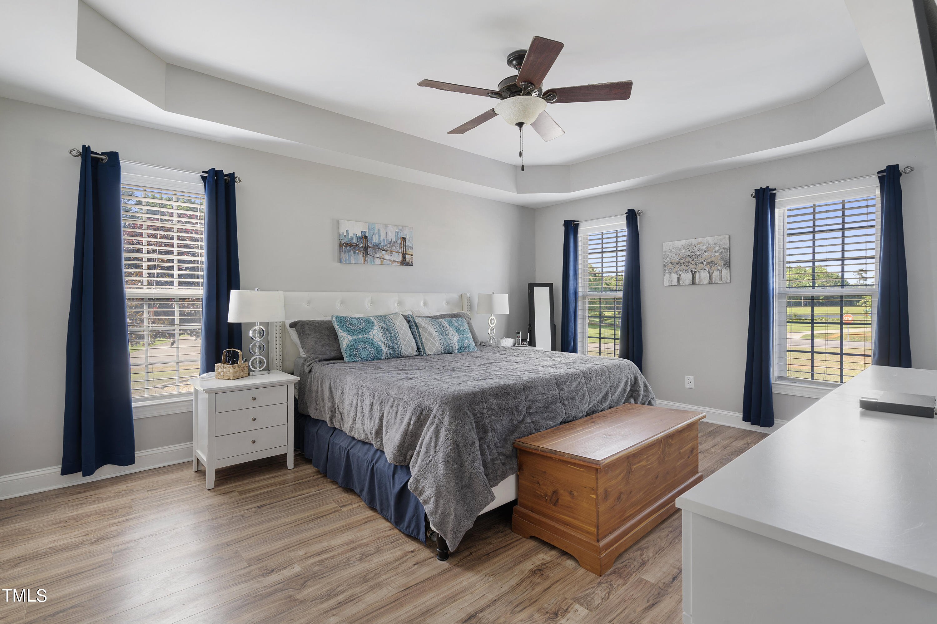 6910 Rock Ridge Sims Road Sims, NC 27880 - Photo 17 of 45 a spacious bedroom with a large bed a chandelier and windows