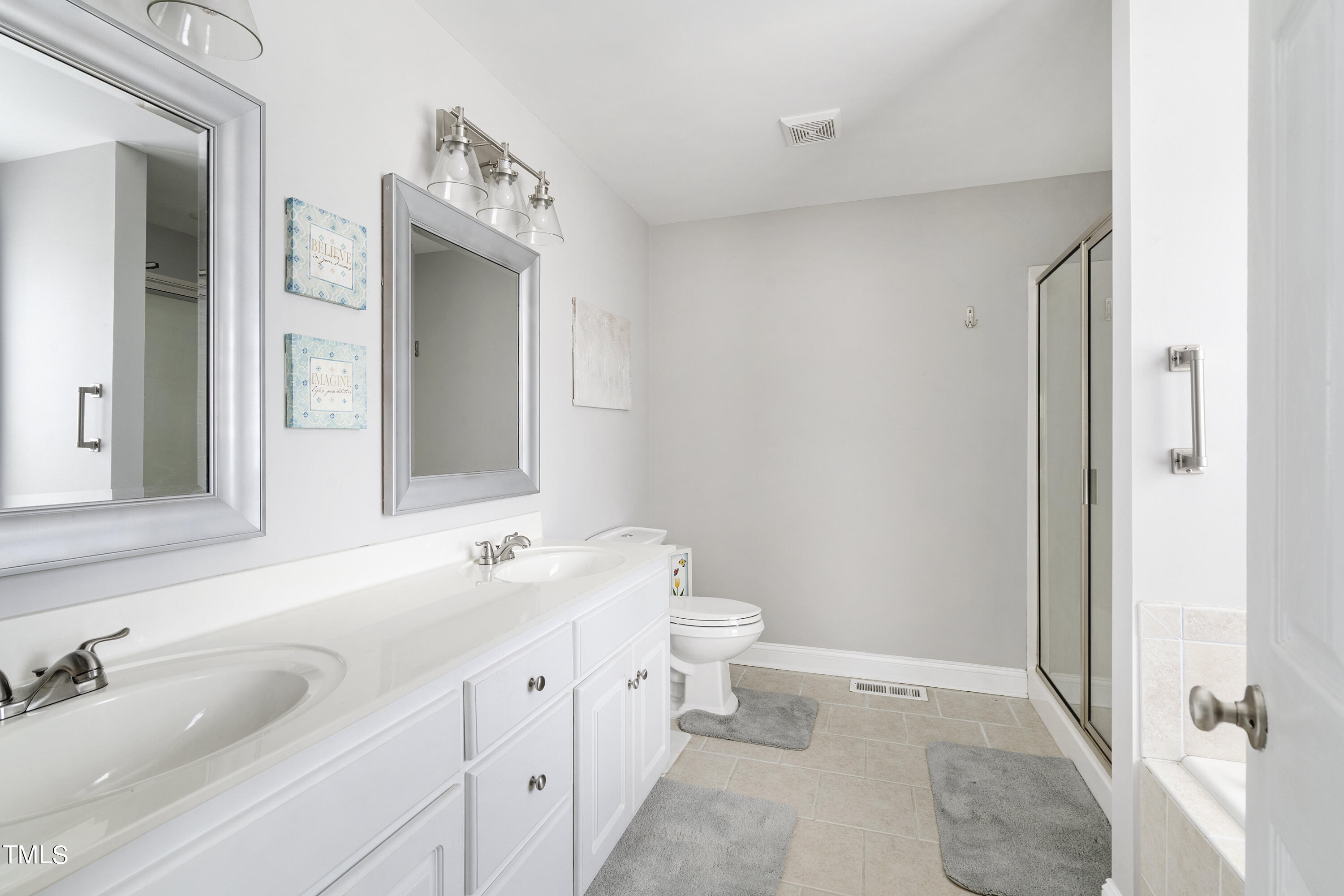 6910 Rock Ridge Sims Road Sims, NC 27880 - Photo 19 of 45 a spacious bathroom with a double vanity sink mirror and toilet