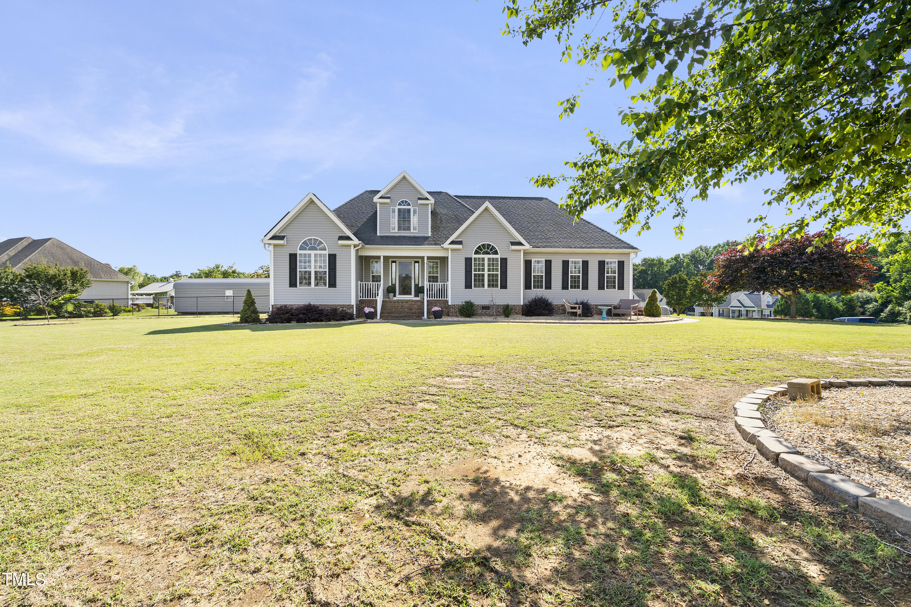 6910 Rock Ridge Sims Road Sims, NC 27880 - Photo 2 of 45 a view of a house with a big yard and palm trees