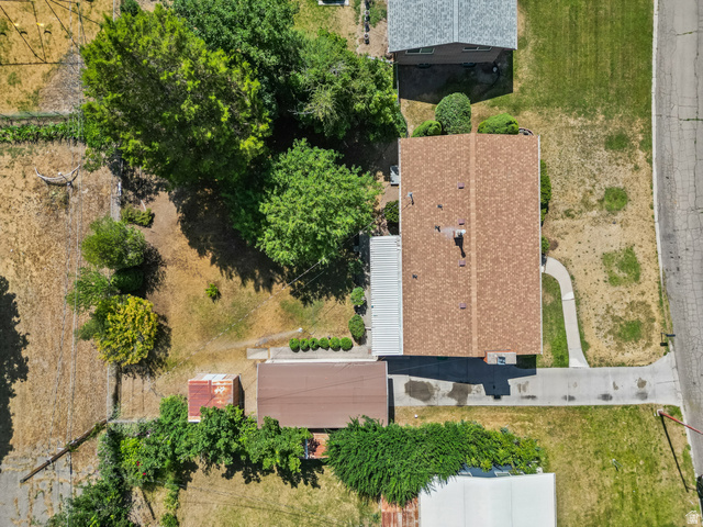 542 East 3400th Street North Provo, UT 84604 - Photo 33 of 39 Aerial property view featuring a brown shingle roof, a paved driveway, and a concrete walkway