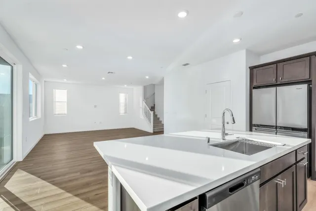a kitchen with a sink cabinets and wooden floor