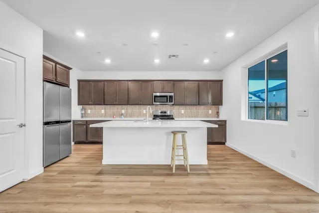 a kitchen with a sink stainless steel appliances and cabinets